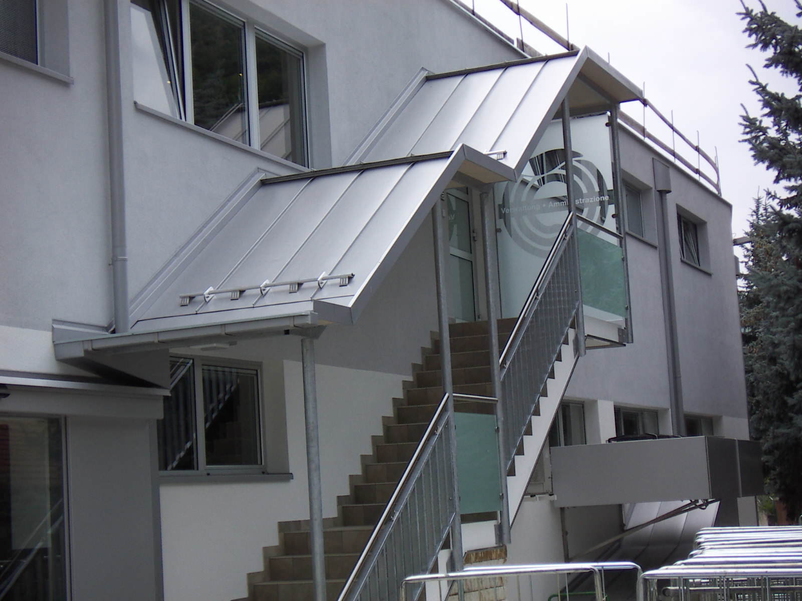 Fertigung, Lieferung und Montage der gesamten Treppenüberdachung mit Treppengeländer und Dacheindeckung in Doppelstehfalz Roofinox .